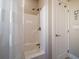 Clean and well-maintained shower with a white shower curtain and a modern shower head at 16109 3Rd E St, Redington Beach, FL 33708