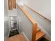 Staircase with wooden handrail, tile flooring and palm tree themed rug runner at 16109 3Rd E St, Redington Beach, FL 33708