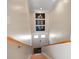 Stairway with wood treads and handrail, leading to a bright entrance with stylish decor at 16109 3Rd E St, Redington Beach, FL 33708