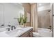 Bathroom featuring double vanity, a large mirror, and tub-shower combination at 1672 Valier Pt, Zephyrhills, FL 33541