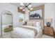Comfortable bedroom with modern lighting, neutral tones, and an oversized equine artwork at 1672 Valier Pt, Zephyrhills, FL 33541