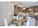 Open-concept kitchen and dining area with stylish light fixtures at 1672 Valier Pt, Zephyrhills, FL 33541