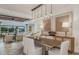 Elegant dining room with modern lighting and an adjacent living area at 1672 Valier Pt, Zephyrhills, FL 33541