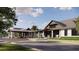 Modern architectural design of a club house with inviting covered entrance and manicured landscape at 1672 Valier Pt, Zephyrhills, FL 33541
