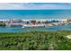 An aerial view captures the community's ideal beachfront location, offering stunning views of the ocean, community pool, and lush surroundings at 18399 Gulf Blvd # 389, Indian Shores, FL 33785