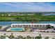 An aerial view showcases the community's prime waterfront location near the pool, waterfront, and beach at 18399 Gulf Blvd # 389, Indian Shores, FL 33785