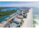 An aerial view highlights the community's stunning waterfront location near the beach, intercoastal waterway, and nearby city amenities at 18399 Gulf Blvd # 389, Indian Shores, FL 33785