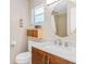 Bright bathroom with a modern vanity, toilet, and framed mirror at 18399 Gulf Blvd # 389, Indian Shores, FL 33785