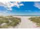 A picturesque beach setting with pristine white sand, clear turquoise water, and sunny skies for ultimate relaxation and recreation at 18399 Gulf Blvd # 389, Indian Shores, FL 33785
