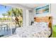 Cozy bedroom with a balcony, offering outdoor seating and views of the surrounding landscape at 18399 Gulf Blvd # 389, Indian Shores, FL 33785