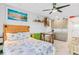 Comfortable living space with a kitchenette, table with stools, and bed with beach-themed decor for a relaxing retreat at 18399 Gulf Blvd # 389, Indian Shores, FL 33785