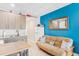 Comfortable living space featuring kitchenette, table, futon, and colorful accents, creating a welcoming and functional area at 18399 Gulf Blvd # 389, Indian Shores, FL 33785