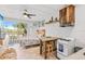 Cozy living space featuring kitchenette, dining table, and a comfortable bed with access to a balcony with outdoor furniture at 18399 Gulf Blvd # 389, Indian Shores, FL 33785