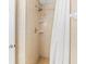Shower features tile surround, shower head, faucet, and built in shelves at 18399 Gulf Blvd # 389, Indian Shores, FL 33785