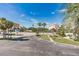 Scenic view of the street, palm trees, and buildings under a bright blue sky at 18399 Gulf Blvd # 389, Indian Shores, FL 33785
