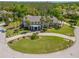 Aerial view of a luxurious residence, showcasing its meticulously landscaped grounds and inviting circular driveway at 19005 Cour Ests, Lutz, FL 33558