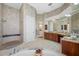 Spacious bathroom featuring a large tub, walk-in shower and double vanity sinks at 19005 Cour Ests, Lutz, FL 33558
