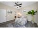 Comfortable bedroom with a ceiling fan, accent lighting, and a view into the ensuite bathroom at 19005 Cour Ests, Lutz, FL 33558