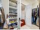 Walk-in closet features custom shelves for shoes and opens into a hallway at 19005 Cour Ests, Lutz, FL 33558