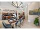 Dining room featuring stylish lighting, a wine bar and seamless access to kitchen at 19005 Cour Ests, Lutz, FL 33558
