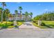 Beautiful home exterior featuring lush lawn, mature landscaping and a circular paver driveway at 19005 Cour Ests, Lutz, FL 33558