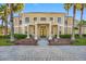 Gorgeous front exterior with double doors, lush landscaping and a beautiful brick paved entry at 19005 Cour Ests, Lutz, FL 33558