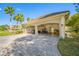 Spacious three-car garage with ample storage and a well-maintained driveway with tropical landscaping at 19005 Cour Ests, Lutz, FL 33558