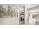 Bright hallway featuring a tiled floor and opening into office space adorned with unique wall art at 19005 Cour Ests, Lutz, FL 33558