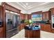 Bright kitchen boasts custom wood cabinets, modern stainless steel appliances, and center island at 19005 Cour Ests, Lutz, FL 33558