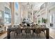 Bright, open-concept living space with dining table and large windows at 19005 Cour Ests, Lutz, FL 33558