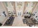 Aerial view of a grand living room with tall windows, elegant decor, and a dining area at 19005 Cour Ests, Lutz, FL 33558