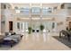 Bright, airy living room featuring soaring ceilings, marble floors and an abundance of natural light at 19005 Cour Ests, Lutz, FL 33558