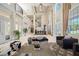Open-concept living room with high ceilings, stylish furnishings and ample space for entertaining at 19005 Cour Ests, Lutz, FL 33558