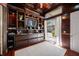 Wood-paneled office features custom shelving, decor, and exterior access to the backyard at 19005 Cour Ests, Lutz, FL 33558
