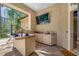 The outdoor kitchen has all appliances, counter space, and screened views of the back yard at 19005 Cour Ests, Lutz, FL 33558