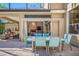 Inviting patio with a dining table and lounge area, seamlessly connecting indoor and outdoor living spaces at 19005 Cour Ests, Lutz, FL 33558