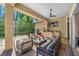Outdoor patio with comfortable seating, an outdoor kitchen, and a screened-in enclosure at 19005 Cour Ests, Lutz, FL 33558