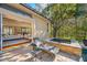 Relaxing patio area with a lounge chair, hot tub, and sliding door access to the home at 19005 Cour Ests, Lutz, FL 33558