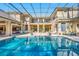 A stunning pool reflects the surrounding home in its cool blue water at 19005 Cour Ests, Lutz, FL 33558