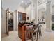 Entertaining wet bar featuring wood cabinetry, bar stool seating and convenient wine storage at 19005 Cour Ests, Lutz, FL 33558