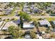 An aerial shot displays a home with a fenced yard, surrounded by verdant landscaping in a peaceful neighborhood at 1901 66Th N Ave, St Petersburg, FL 33702
