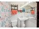 Charming bathroom with bright lighting, decorative shower curtain, and pedestal sink at 1901 66Th N Ave, St Petersburg, FL 33702