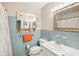 Well-lit bathroom features a vanity sink, and blue tile backsplash at 1901 66Th N Ave, St Petersburg, FL 33702