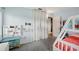 Bright bedroom features a bunk bed, wall shelving, and cozy carpet flooring at 1901 66Th N Ave, St Petersburg, FL 33702