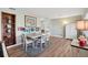 Bright dining room featuring a white table, wood floors, and a decorative bookshelf at 1901 66Th N Ave, St Petersburg, FL 33702