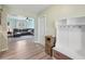 Light and airy entryway featuring wood-look flooring, coat rack, and a view into the living room at 1901 66Th N Ave, St Petersburg, FL 33702