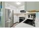 Bright kitchen with white cabinets, stainless steel refrigerator, and modern appliances, creating a clean, contemporary space at 1901 66Th N Ave, St Petersburg, FL 33702