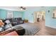 Comfortable living room with a large sectional sofa, ceiling fan, and light-colored walls at 1901 66Th N Ave, St Petersburg, FL 33702
