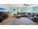 Spacious living room featuring a large leather sectional sofa, modern TV, and a cozy rug at 1901 66Th N Ave, St Petersburg, FL 33702