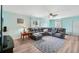Bright living room with a comfortable sectional sofa, ceiling fan, and natural light from the windows at 1901 66Th N Ave, St Petersburg, FL 33702